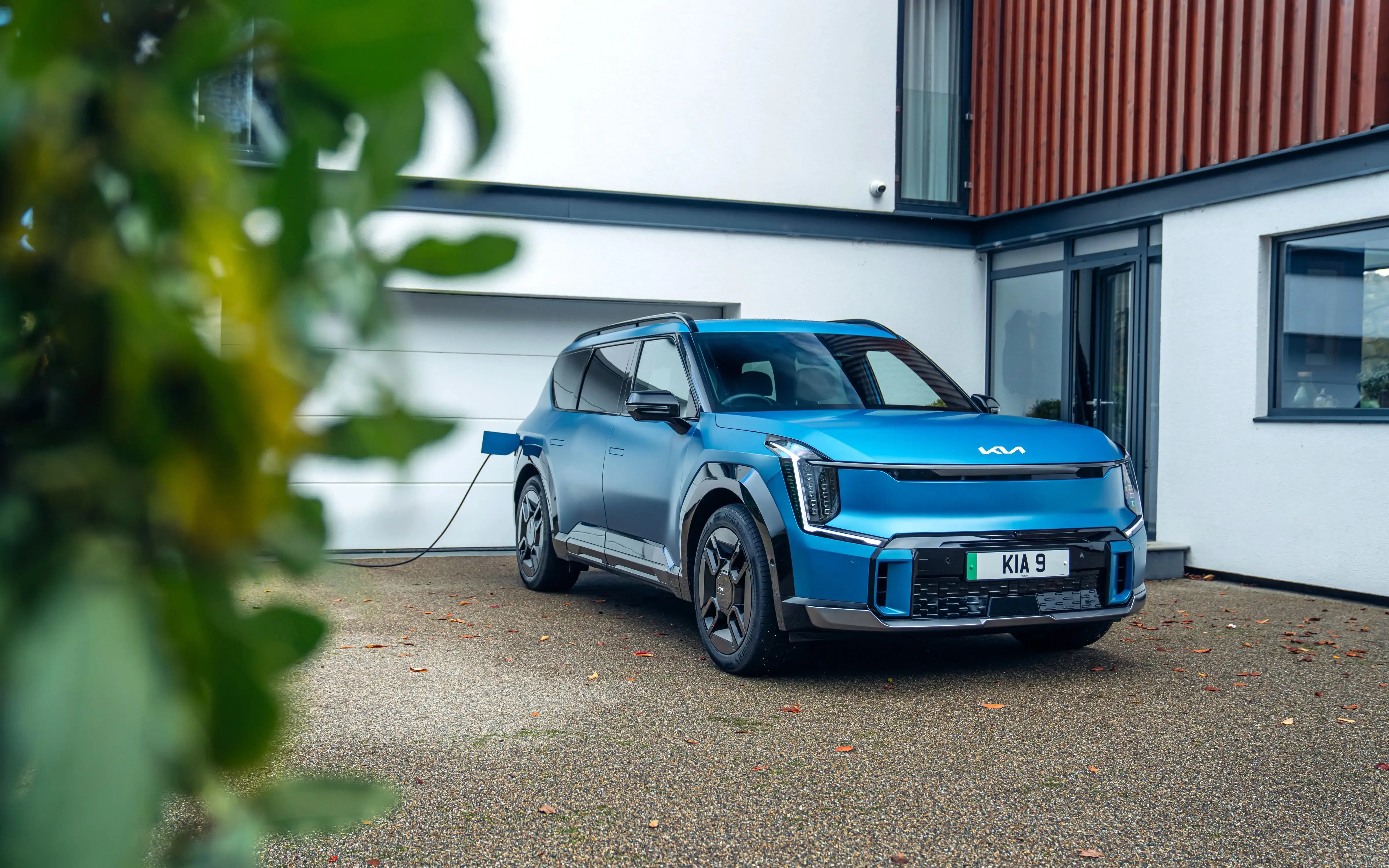 blue-Kia-EV9-parked-driveway