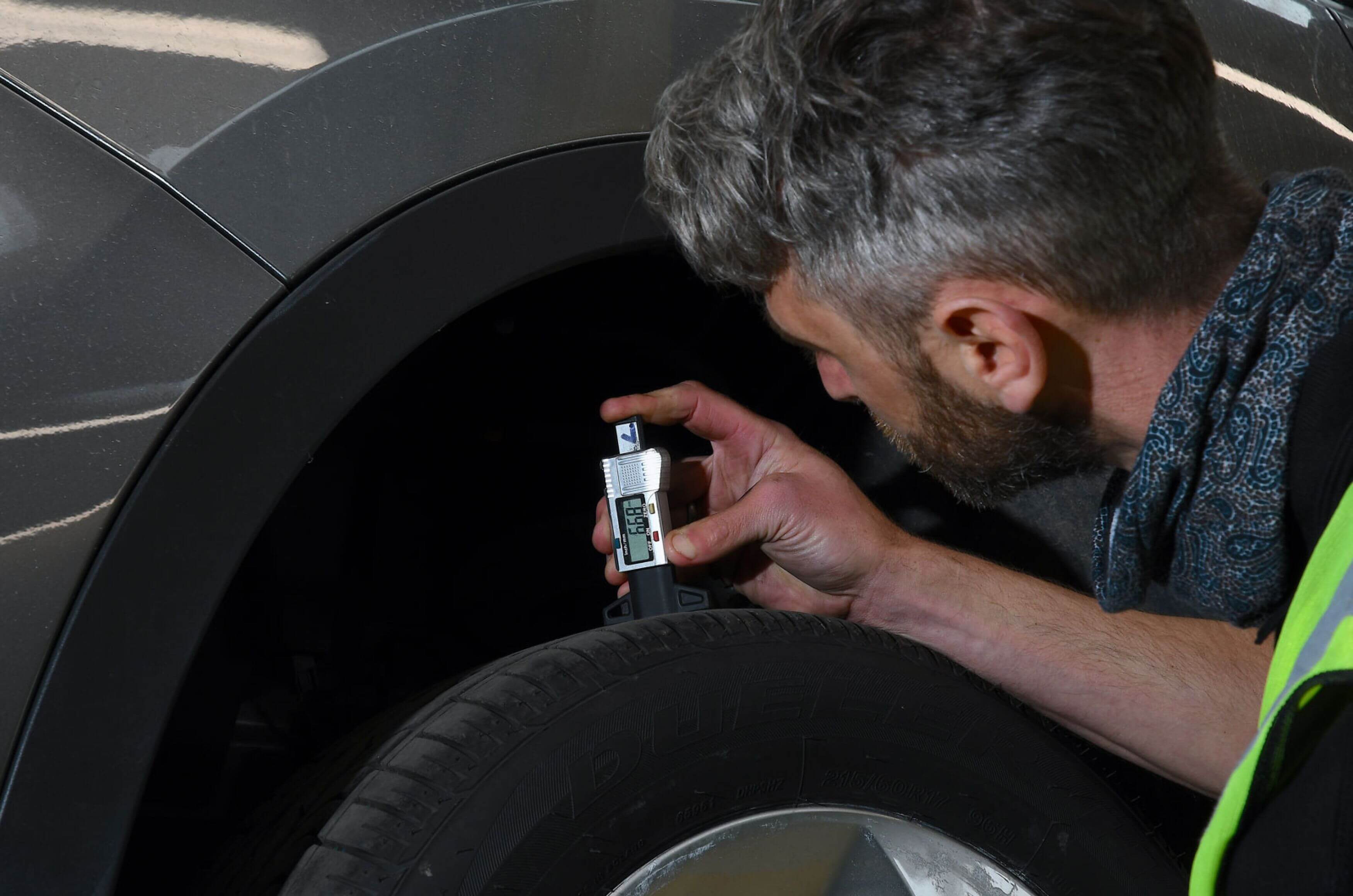 mechanic-checking-tyre-tread-depth